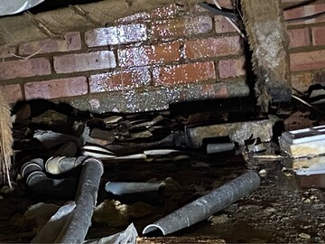 Saturated subfloor and concealed pipework exposed during leak detection in Little Chalfont